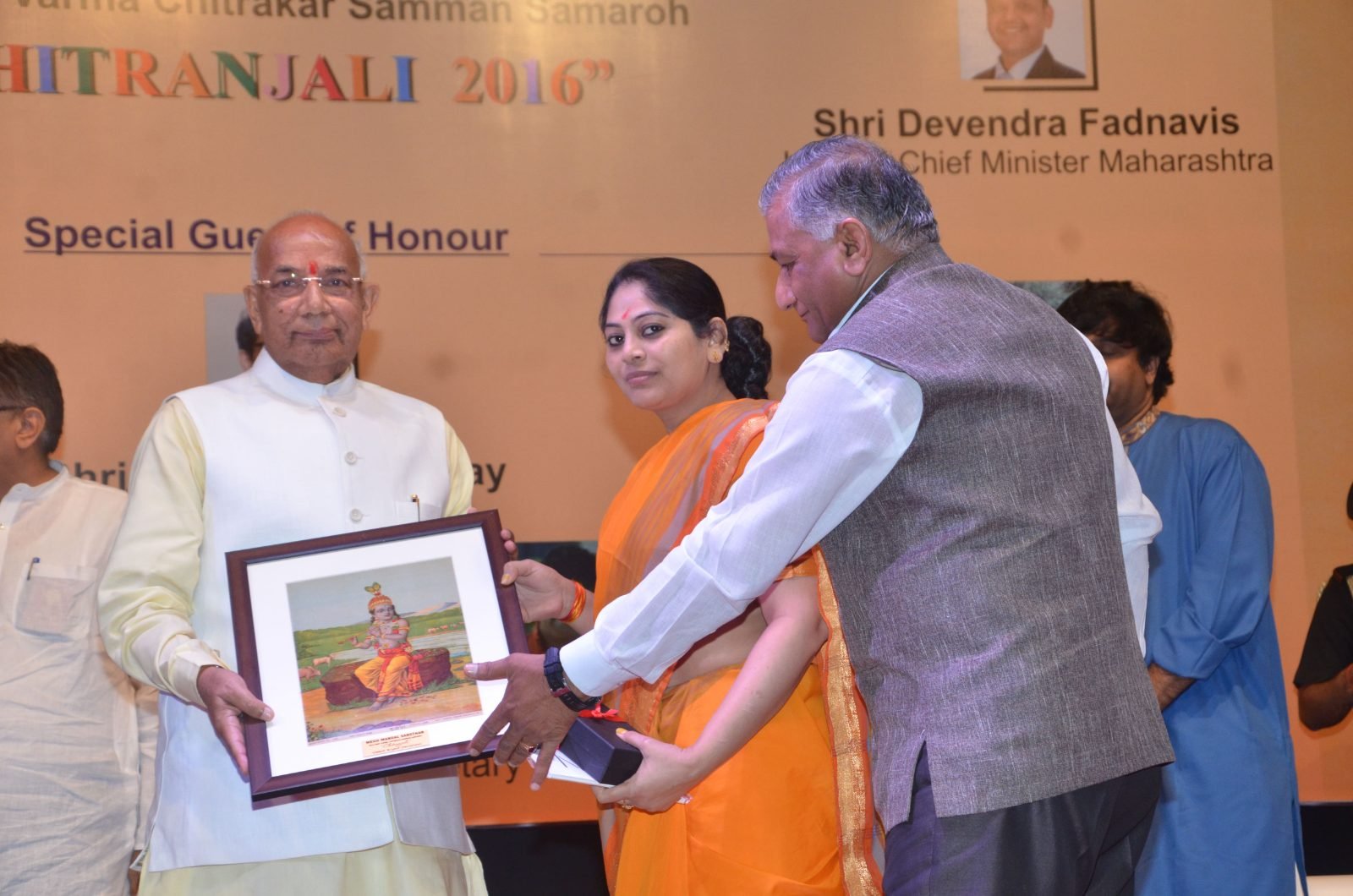 A framed Raja Ravi Varma print being presented to the Chief Guest at Chitranjali 2016