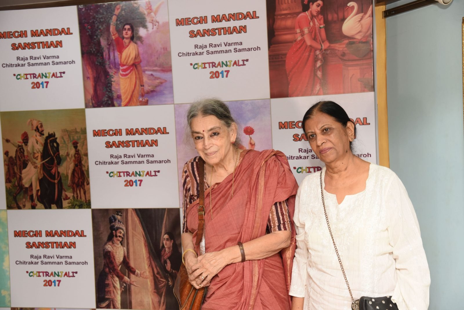 Two guests photographed against the Chitranjali 2017 backdrop
